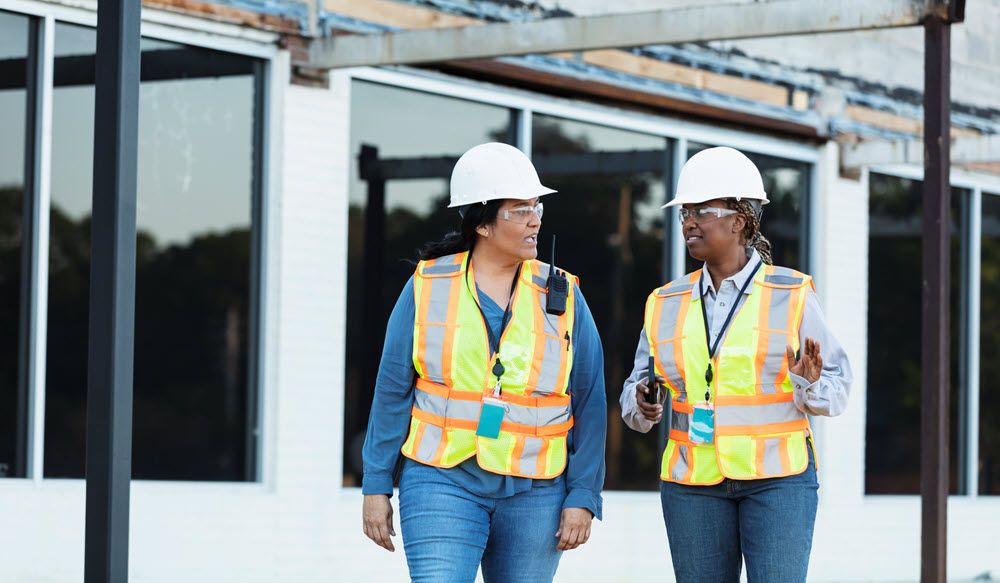 Two tradeswomen on a job site.