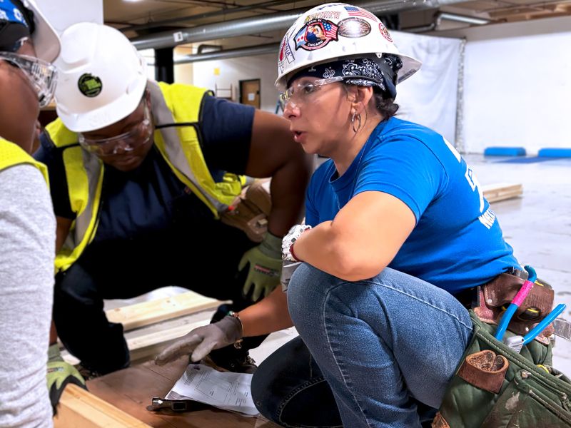 Two tradeswomen on a job site.