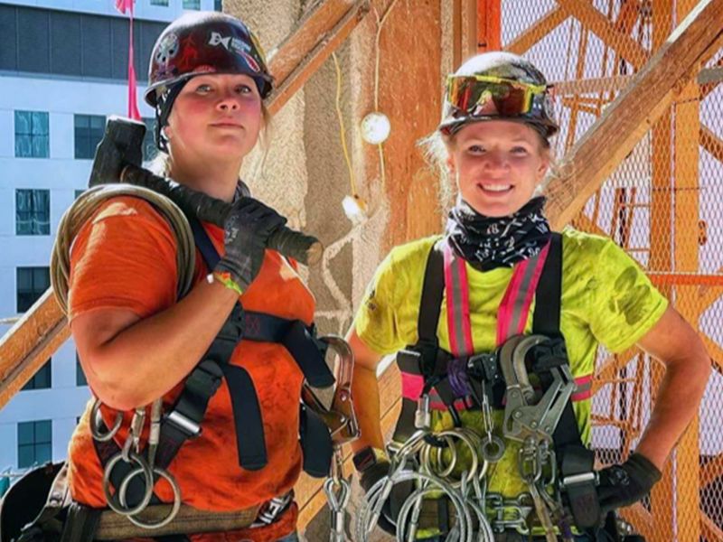 Two tradeswomen on a job site.